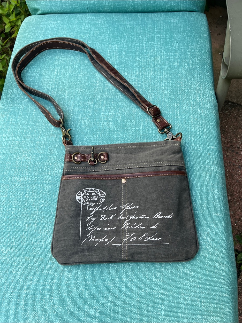 Myra Bag gray crossbody with brown trim and white script